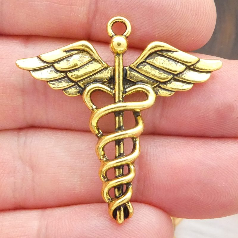 caduceus pendants for jewelry making in gold pewter closeup